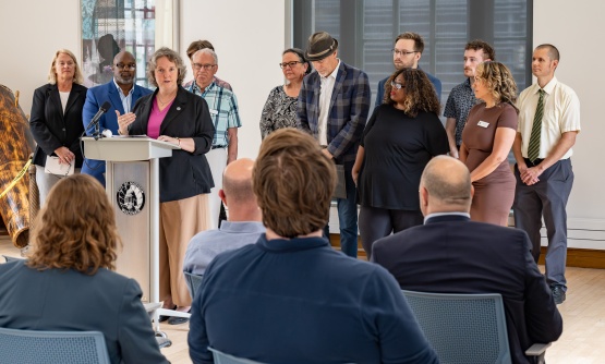 City leaders standing at a podium in the Madison Municipal Building